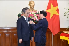 Le ministre vietnamien des Affaires étrangères Bui Thanh Son (droite) remet le 8 mai à Hanoï l’Insigne "Pour la cause de la diplomatie vietnamienne" à l'ambassadeur du Japon au Vietnam, Yamada Takio. Photo : VNA